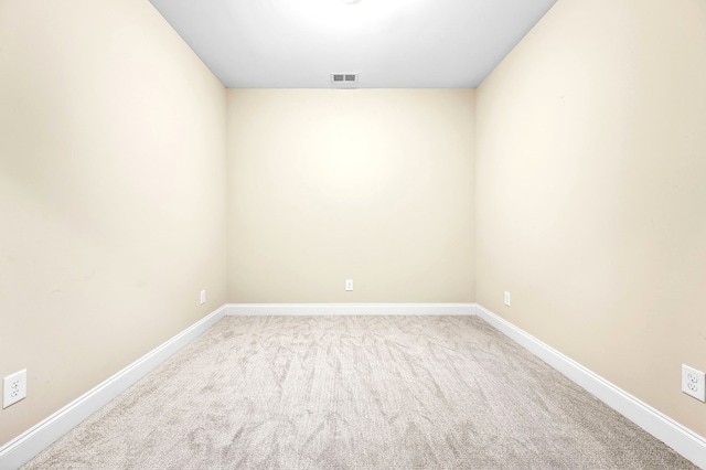 spare room featuring light colored carpet