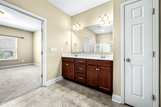 bathroom featuring vanity and a shower with door