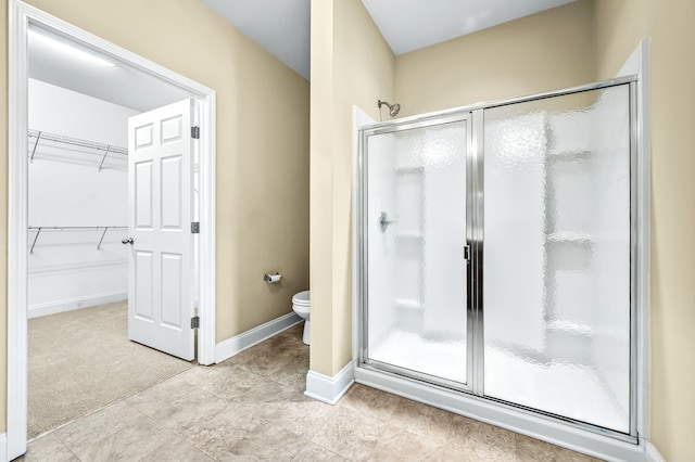 bathroom featuring an enclosed shower and toilet