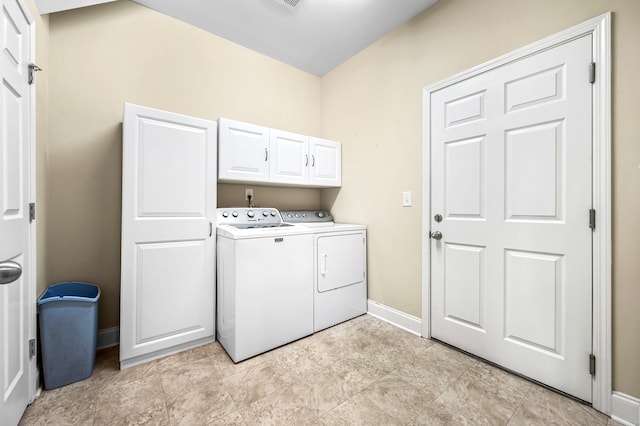 laundry room with cabinets and washing machine and clothes dryer