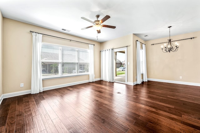 unfurnished living room featuring ceiling fan with notable chandelier and dark wood-type flooring