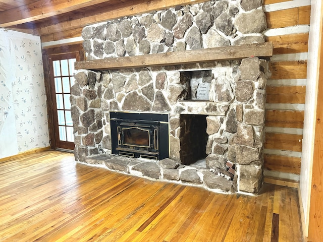 interior details featuring a wood stove and hardwood / wood-style flooring