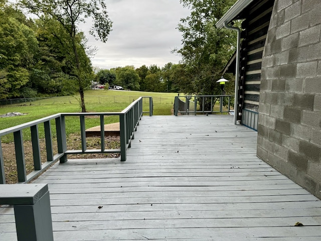 wooden terrace featuring a yard