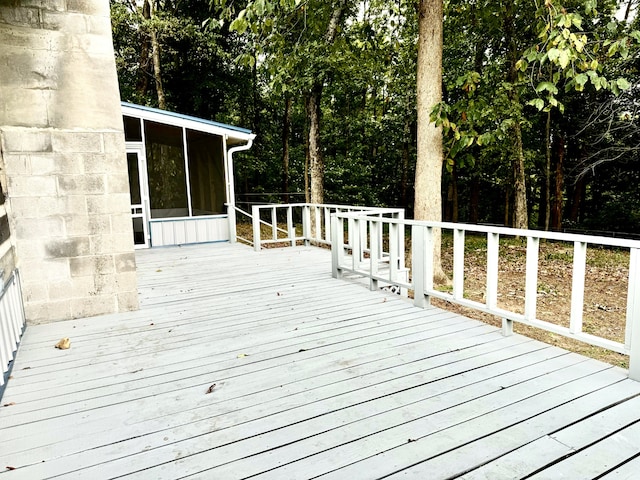 wooden terrace featuring a sunroom