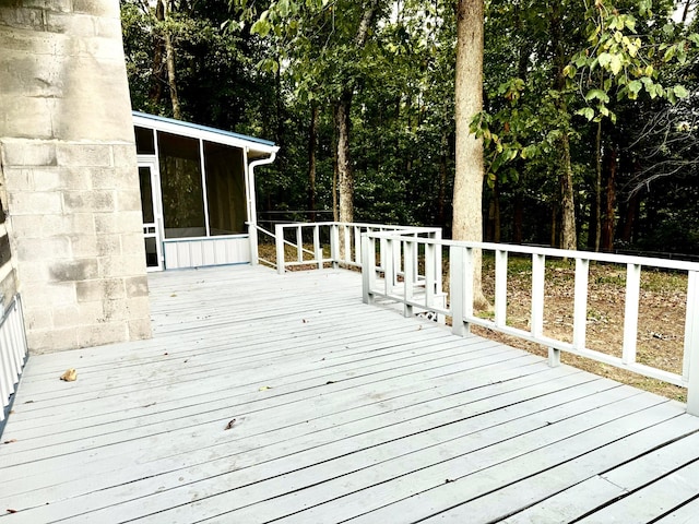 wooden deck with a sunroom