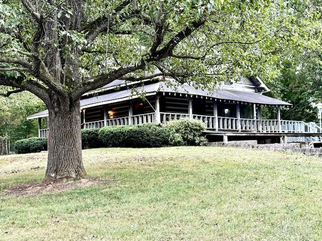 farmhouse inspired home with a deck and a front yard