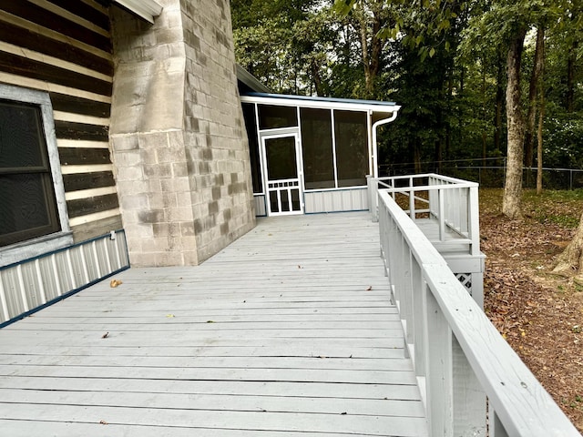 wooden deck with a sunroom and fence