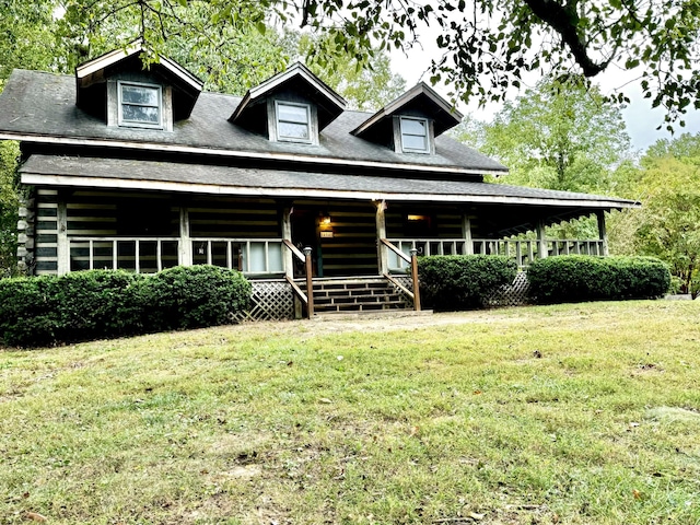 view of front facade with log exterior, a porch, and a front yard