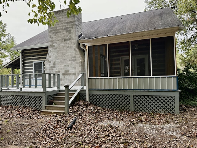 back of house with a sunroom and a deck