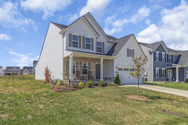 view of front of house featuring a front lawn, covered porch, and a garage