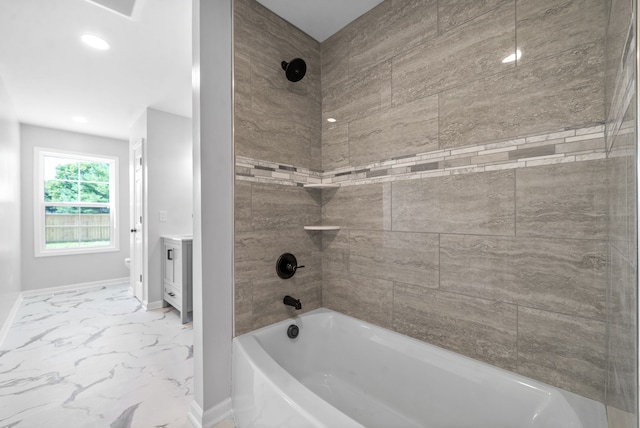 bathroom with tiled shower / bath combo and vanity