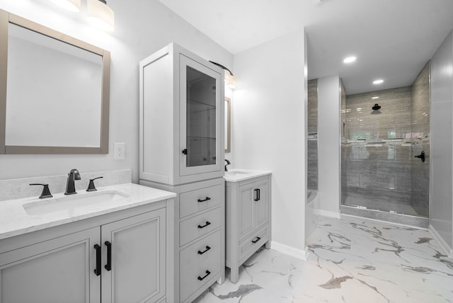 bathroom featuring tiled shower and vanity