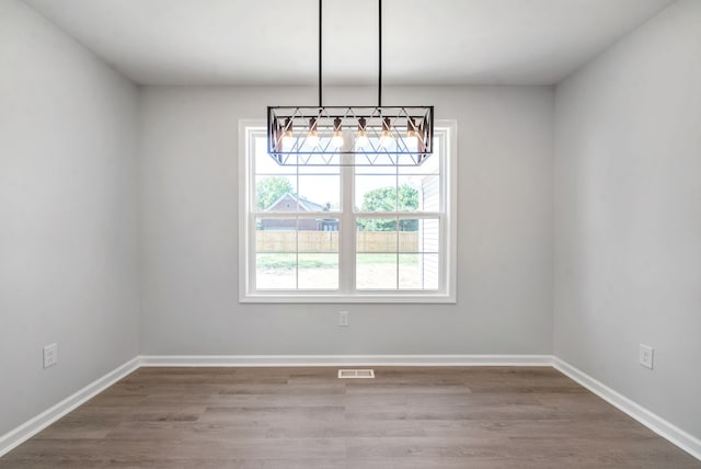 unfurnished dining area with hardwood / wood-style flooring