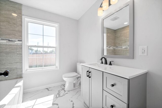 full bathroom with tiled shower / bath combo, vanity, and toilet