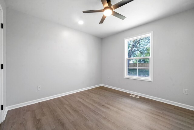 spare room with hardwood / wood-style floors and ceiling fan