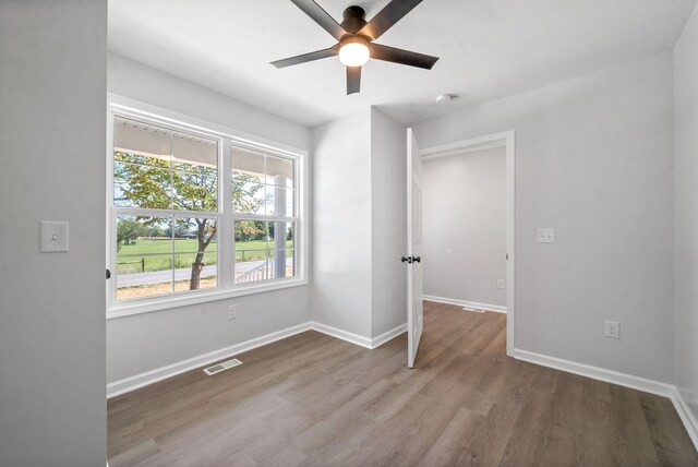 unfurnished bedroom featuring hardwood / wood-style floors and ceiling fan