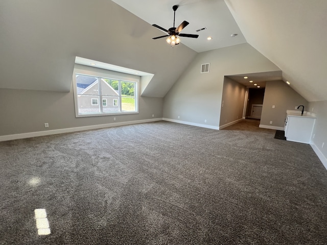 bonus room featuring ceiling fan, lofted ceiling, and dark colored carpet