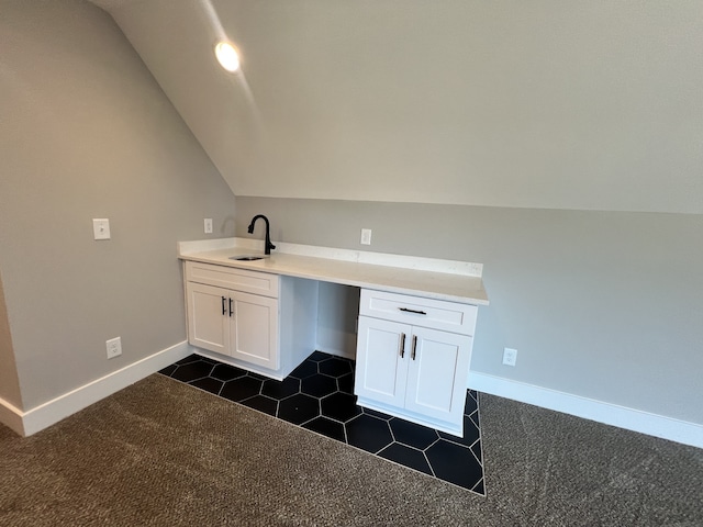 bathroom with vaulted ceiling and sink