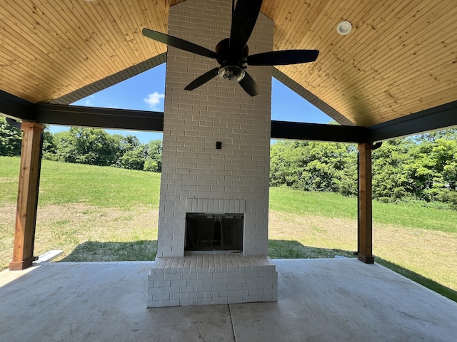 view of patio featuring ceiling fan and an outdoor brick fireplace