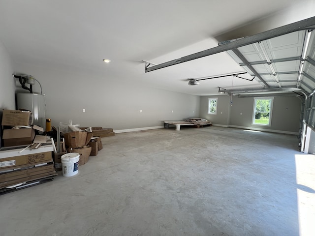 garage featuring water heater and a garage door opener