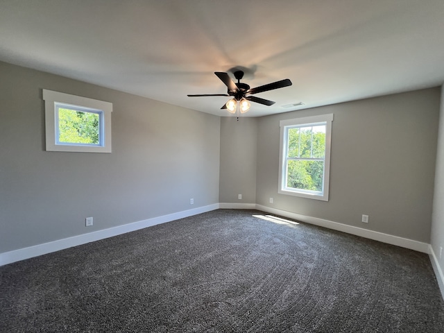 carpeted spare room featuring ceiling fan