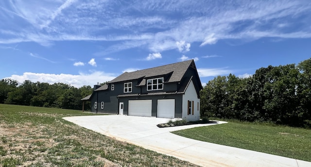 view of front of house with a front lawn and a garage