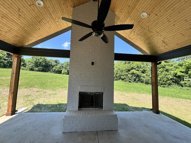 view of patio featuring ceiling fan and an outdoor brick fireplace