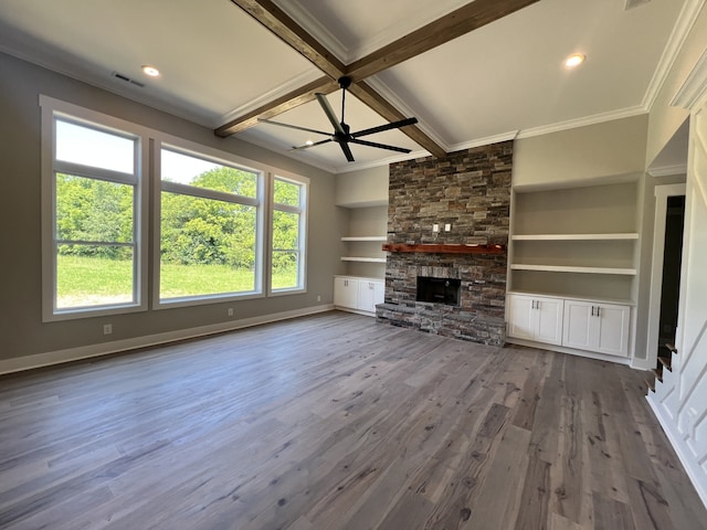 unfurnished living room featuring ceiling fan, beamed ceiling, built in features, hardwood / wood-style flooring, and a fireplace