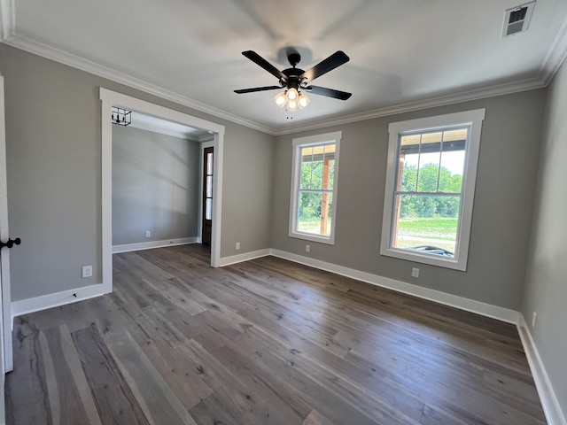 spare room featuring ornamental molding, dark hardwood / wood-style floors, ceiling fan, and plenty of natural light