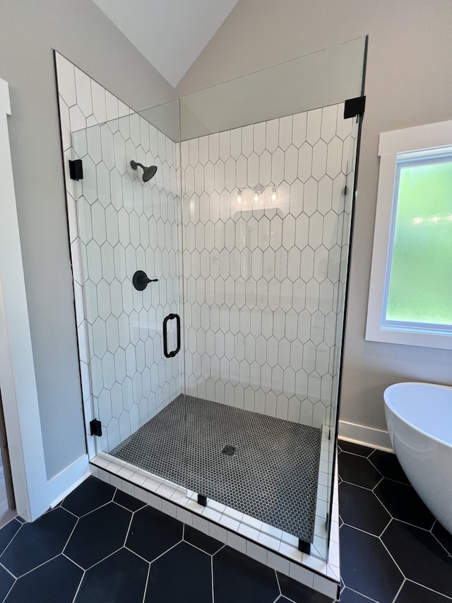 bathroom with lofted ceiling, separate shower and tub, and tile patterned floors