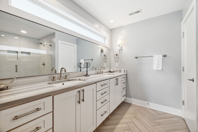 bathroom featuring vanity, parquet floors, and an enclosed shower