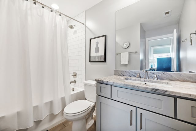 full bathroom with shower / bath combo, vanity, and toilet