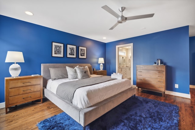 bedroom with ceiling fan, dark hardwood / wood-style floors, and ensuite bathroom