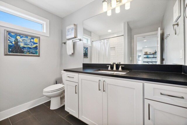 bathroom with a shower with shower curtain, tile patterned flooring, vanity, and toilet