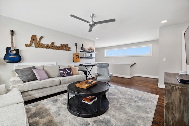 living room featuring ceiling fan and dark hardwood / wood-style flooring