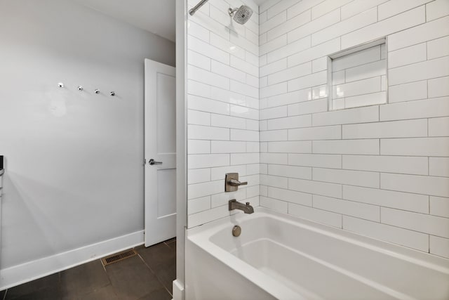 bathroom featuring tiled shower / bath combo and tile patterned floors