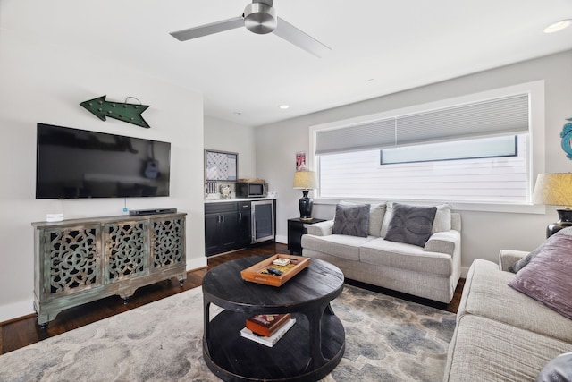 living room featuring dark hardwood / wood-style floors, ceiling fan, and beverage cooler