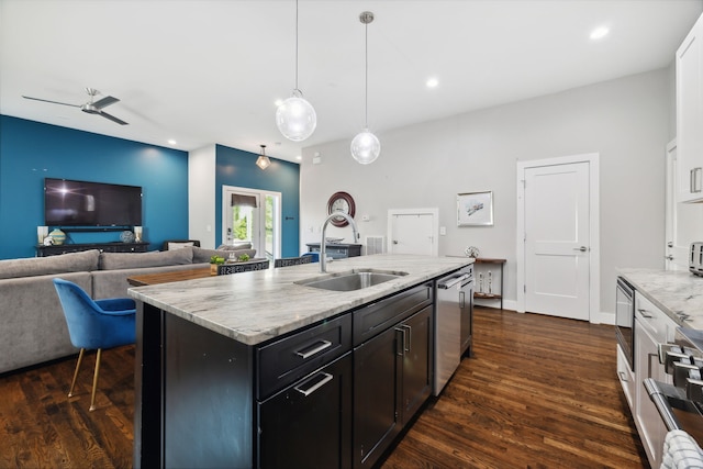 kitchen featuring dark hardwood / wood-style floors, sink, a center island with sink, decorative light fixtures, and ceiling fan