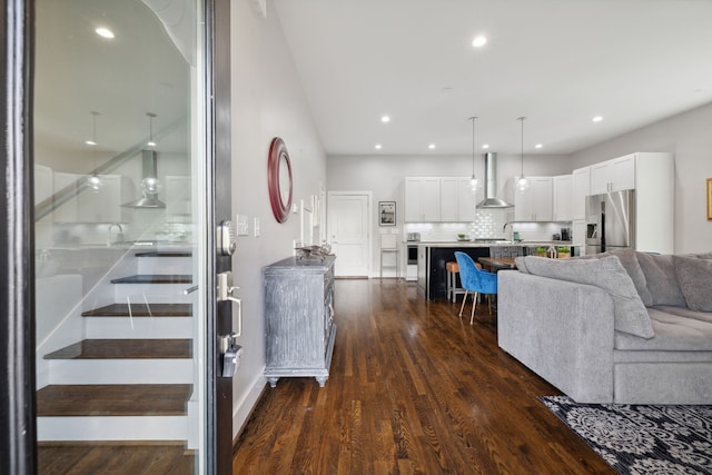 living room with dark hardwood / wood-style floors and sink