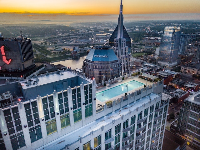 aerial view at dusk featuring a water view