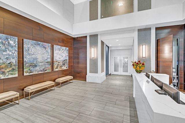 interior space featuring french doors and a towering ceiling