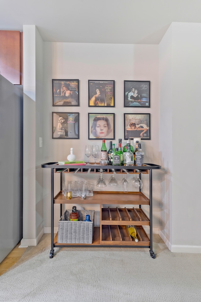 interior space featuring bar and carpet