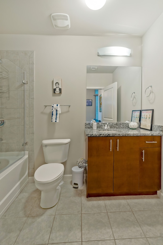 full bathroom featuring toilet, vanity, tile patterned floors, and tiled shower / bath combo