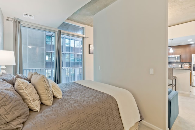 carpeted bedroom with stainless steel fridge with ice dispenser