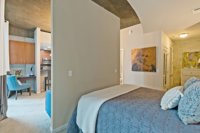 bedroom featuring light carpet