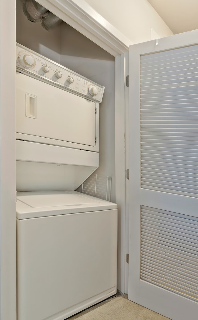 laundry area with stacked washing maching and dryer