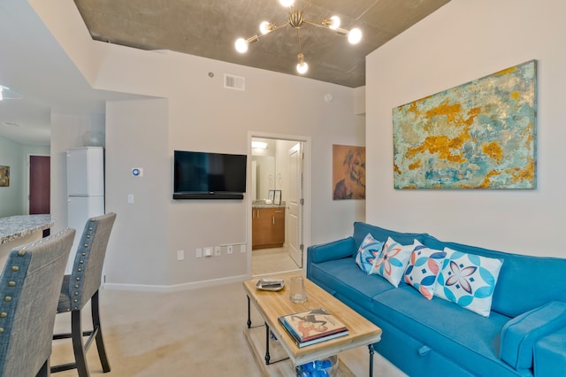 carpeted living room with a chandelier