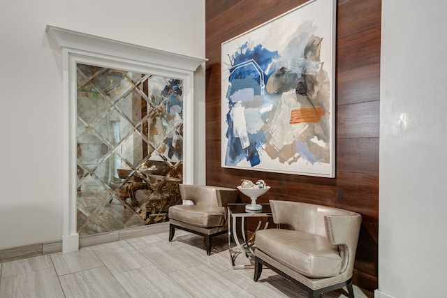 sitting room featuring wood walls