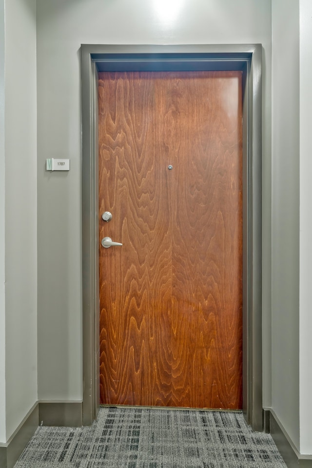 doorway to outside with tile patterned floors