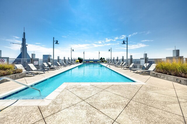 pool featuring a patio and fence